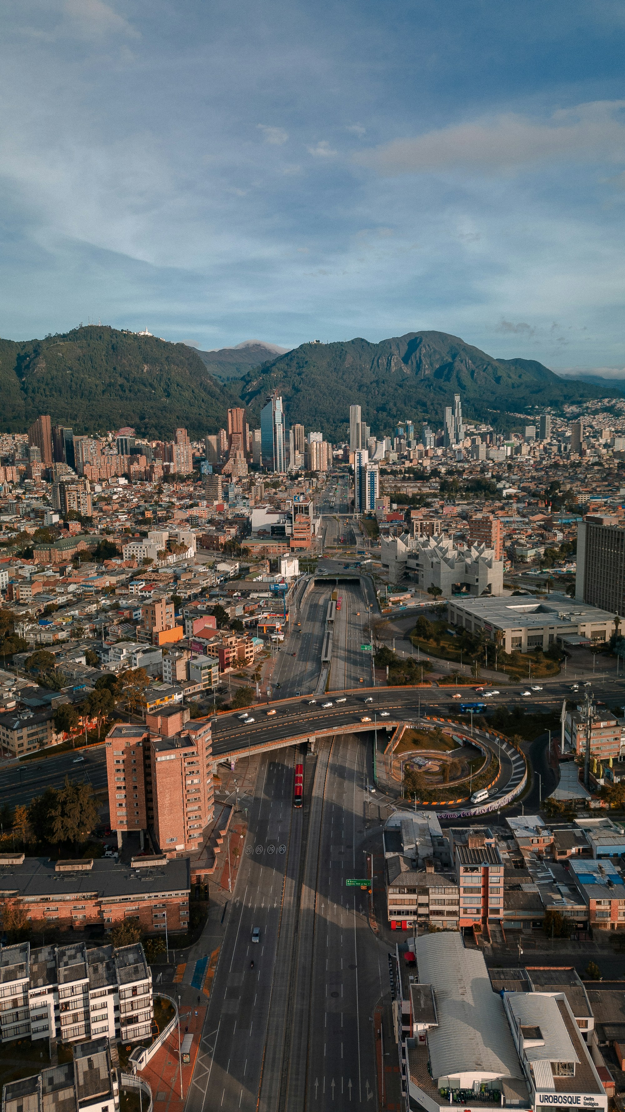 Aerial view of Bogotá's financial district and main avenue, the Andes rising behind